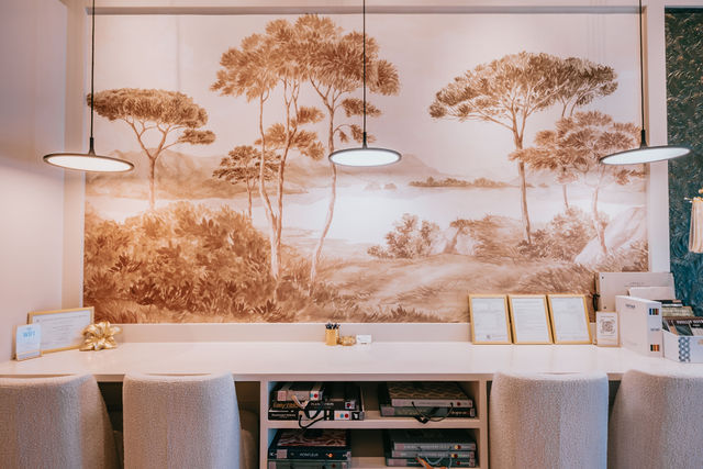 A hand turns pages of a wallpaper sample book
